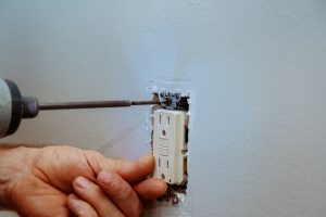 Wall socket installation a screw on an electrical outlet